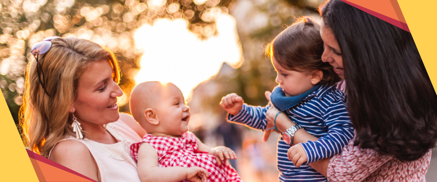Photograph of two Mums introducing their children to each other in an autumn setting, with origami shapes overlaid decorating the corners